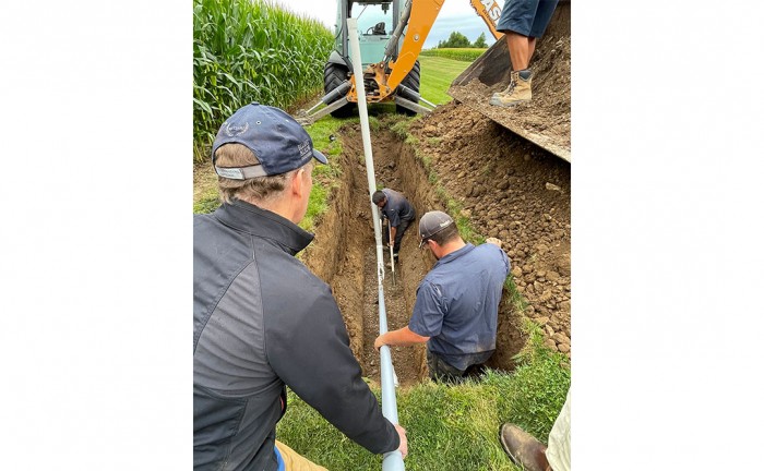 Filling a trench at Huronview Demonstration Farm.